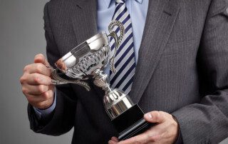 image of man holding award